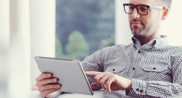 man on tablet searching for alternative loans