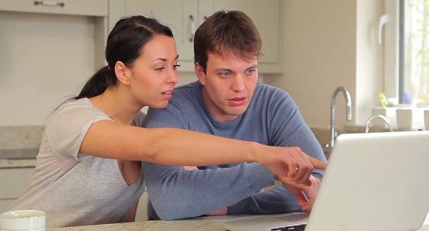 Confused couple on laptop