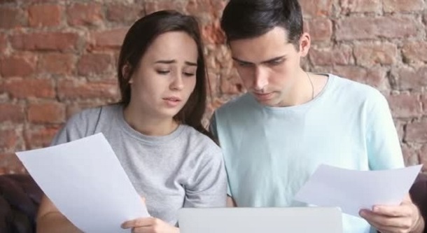 Couple looking at loan agreement