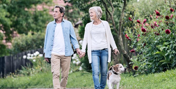 Older Couple walking dog