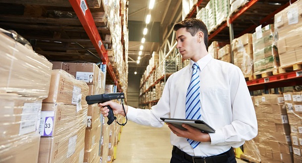 Man in warehouse checking invoices