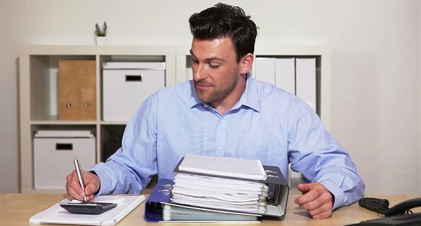 Man with pension scheme information on desk